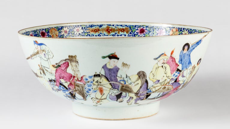 The bowl is painted showing male figures in Manchu dress mounted on horses carrying bows and arrows, one appears to hold a matchlock, perhaps with a bayonet, they are chasing deer and a leopard,